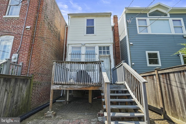 back of property featuring a wooden deck