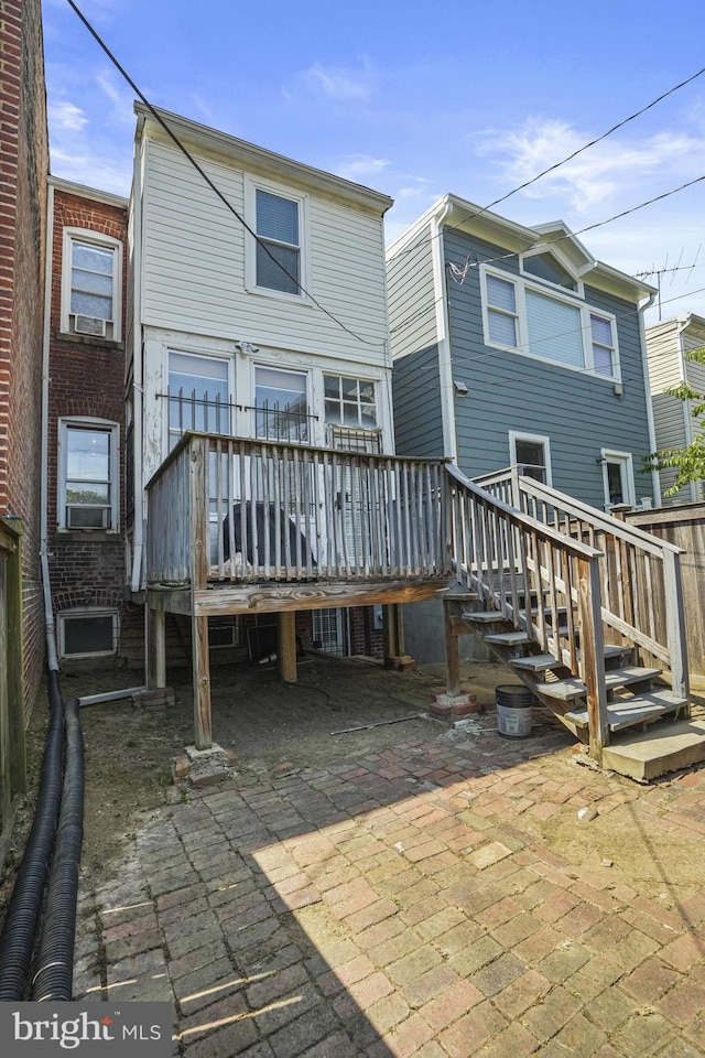 rear view of house with a patio area and a wooden deck