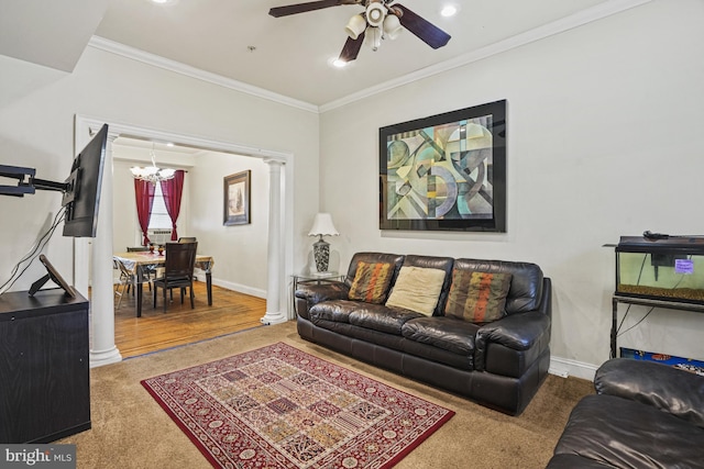 carpeted living room with ceiling fan with notable chandelier, ornamental molding, and decorative columns