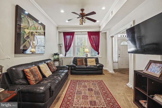 carpeted living room featuring ornate columns, ceiling fan, and ornamental molding