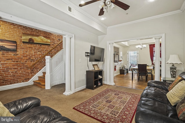 living room featuring ceiling fan with notable chandelier, carpet floors, crown molding, and brick wall