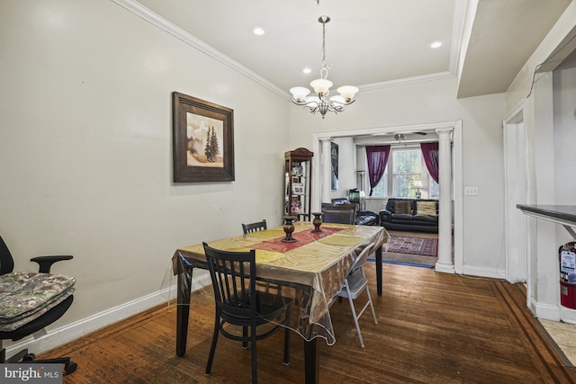 dining room featuring hardwood / wood-style floors, ornamental molding, and an inviting chandelier