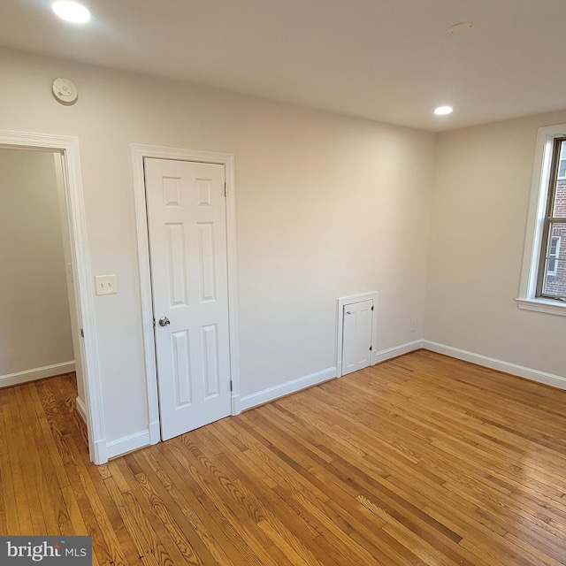 spare room with light hardwood / wood-style flooring