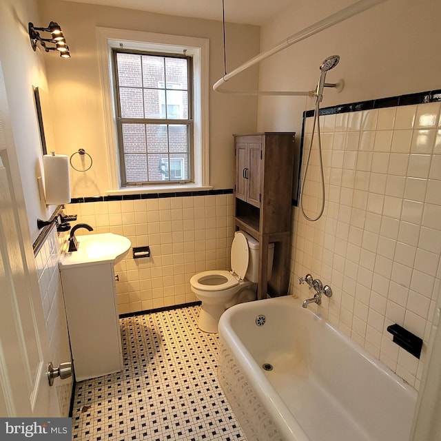 full bathroom featuring shower / bathtub combination, vanity, tile walls, tile patterned flooring, and toilet