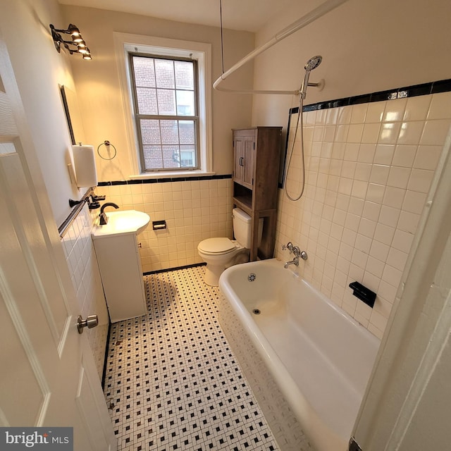 full bathroom with vanity, shower / tub combination, tile patterned flooring, toilet, and tile walls