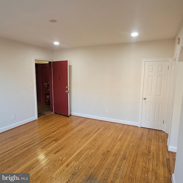 unfurnished room with light wood-type flooring