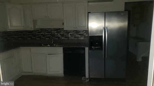 kitchen featuring white cabinetry, dishwasher, sink, stainless steel fridge, and decorative backsplash