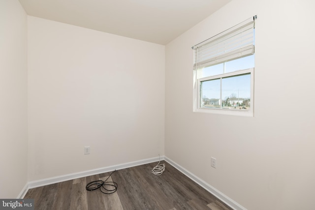 unfurnished room with dark hardwood / wood-style floors