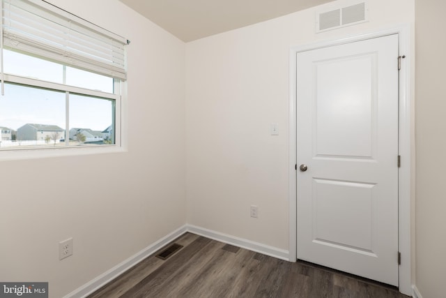 spare room with dark hardwood / wood-style floors