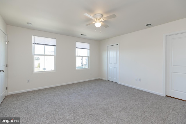 unfurnished bedroom with ceiling fan and light carpet