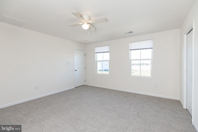 unfurnished bedroom with ceiling fan and light carpet