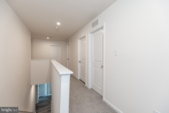 hallway with light colored carpet