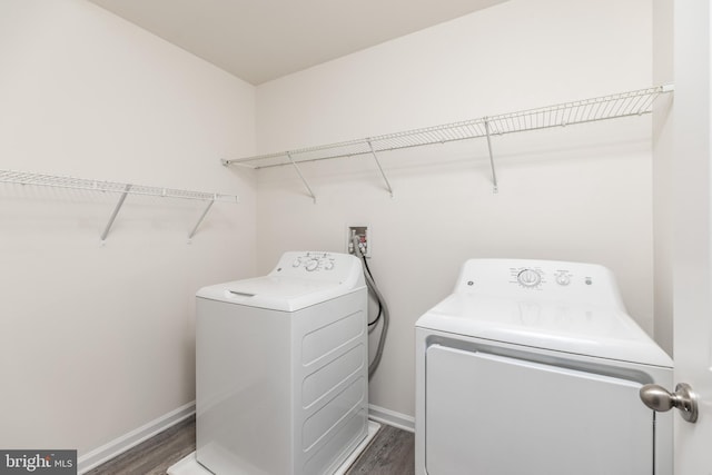 laundry room featuring dark hardwood / wood-style flooring and separate washer and dryer