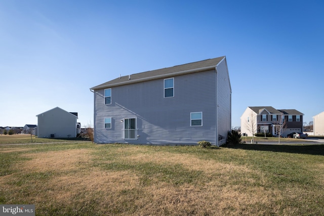 rear view of property featuring a yard