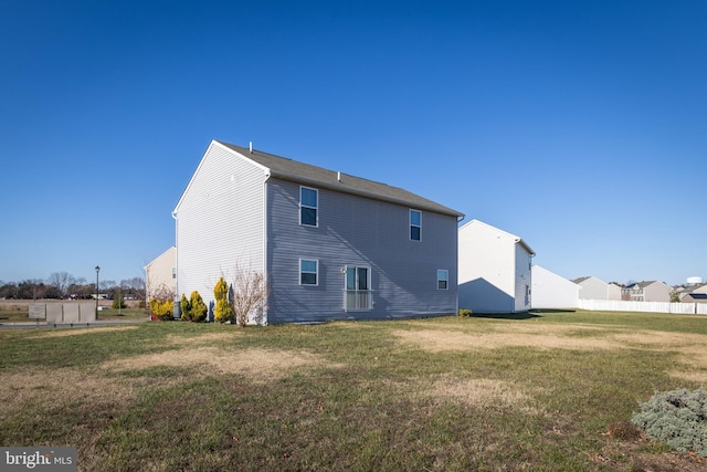 back of house featuring a yard