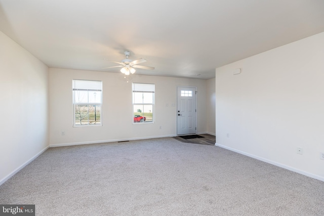 unfurnished living room featuring carpet floors and ceiling fan