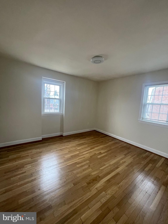 unfurnished room featuring hardwood / wood-style flooring