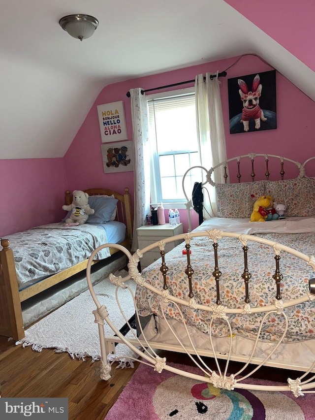 bedroom featuring hardwood / wood-style floors and vaulted ceiling