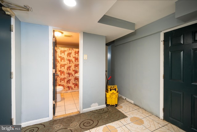 basement with light tile patterned flooring