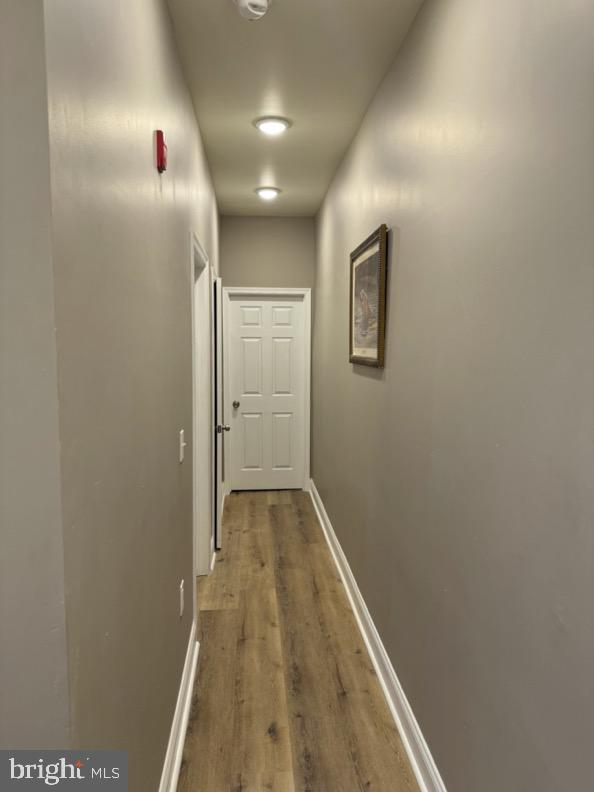 corridor with wood-type flooring