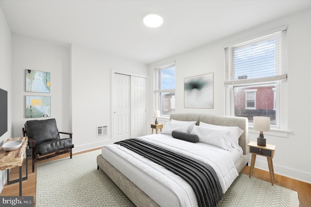 bedroom with wood-type flooring and a closet