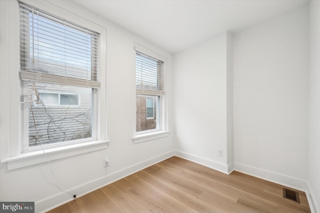 spare room featuring light wood-type flooring