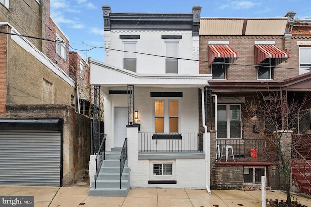 multi unit property with a balcony and a porch