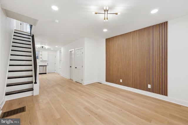 interior space with light wood-type flooring and a chandelier