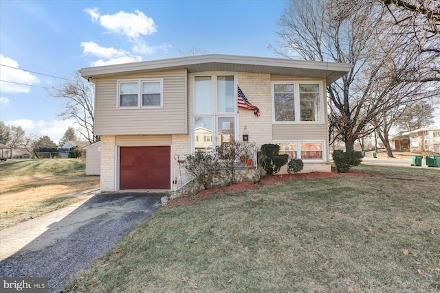 split foyer home with a garage and a front lawn