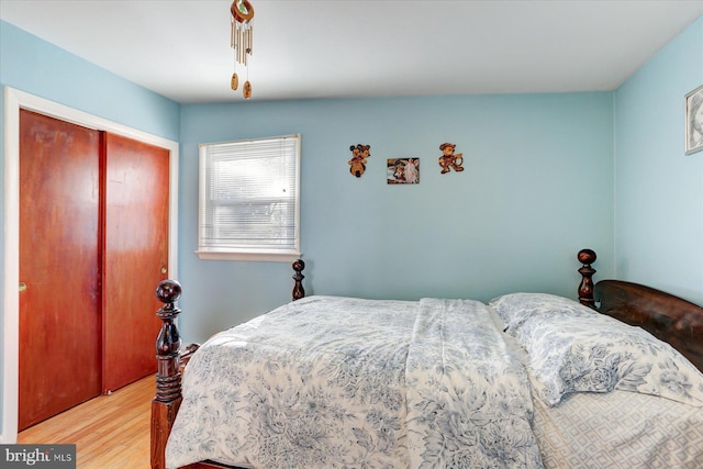 bedroom featuring hardwood / wood-style floors and a closet