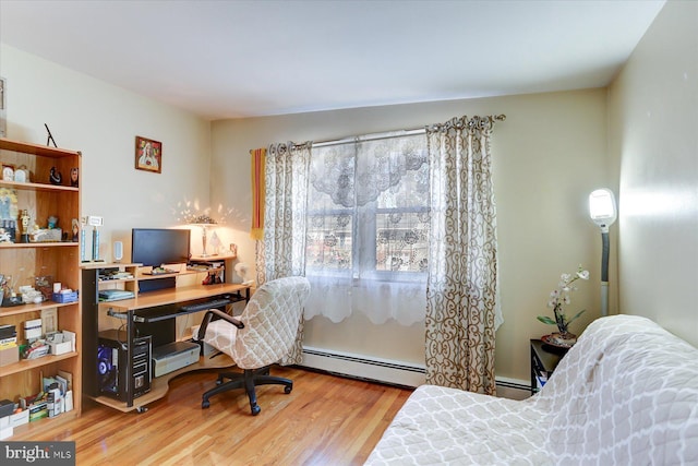 office space featuring hardwood / wood-style floors and a baseboard heating unit