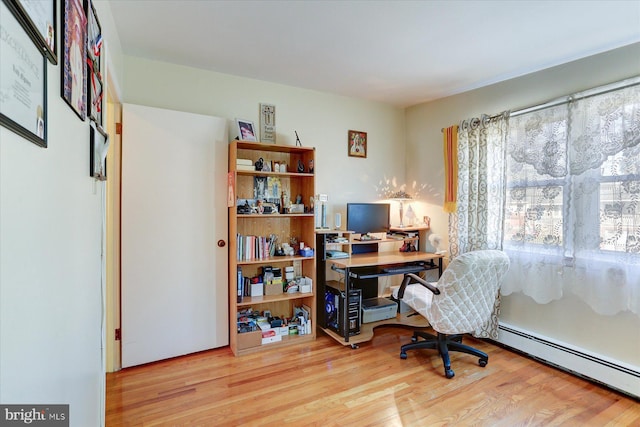 office area with light wood-type flooring and baseboard heating