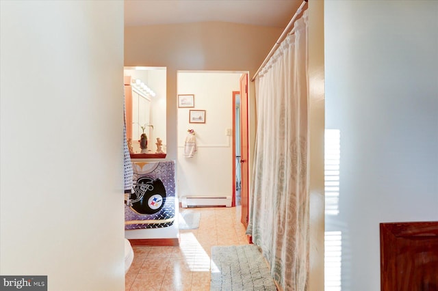 corridor featuring light tile patterned floors and a baseboard radiator