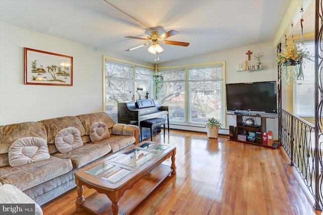 living room with ceiling fan, a baseboard radiator, and light wood-type flooring