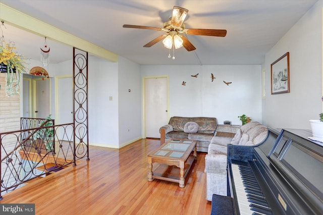 living room with hardwood / wood-style floors and ceiling fan