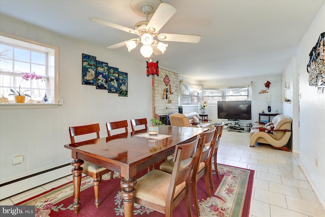 tiled dining area featuring ceiling fan and a baseboard heating unit