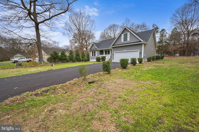 view of front of property with a garage and a front lawn