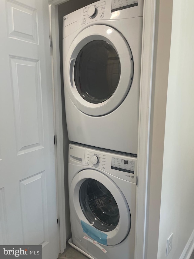 laundry area with stacked washer and dryer