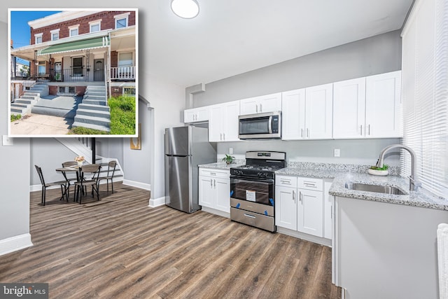 kitchen featuring dark hardwood / wood-style flooring, sink, white cabinets, and stainless steel appliances