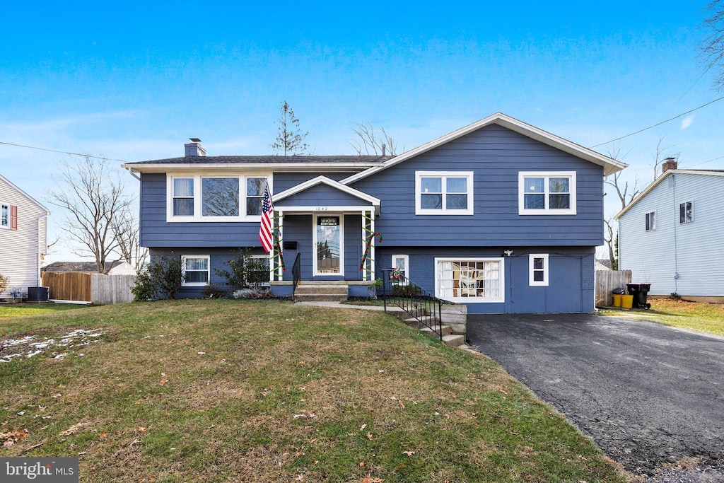 raised ranch with a front yard