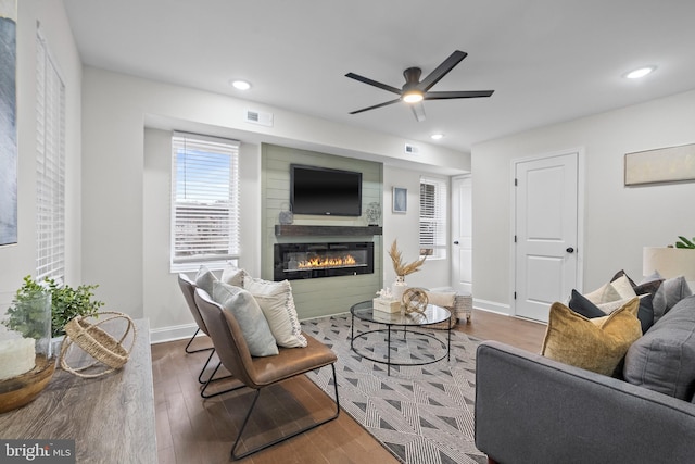 living room with dark hardwood / wood-style floors and ceiling fan