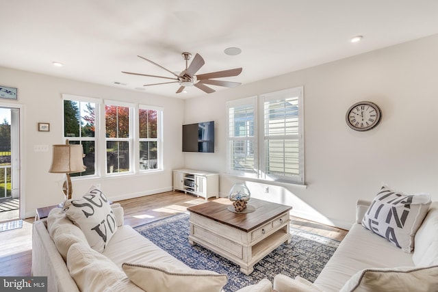 living room with ceiling fan and light hardwood / wood-style floors