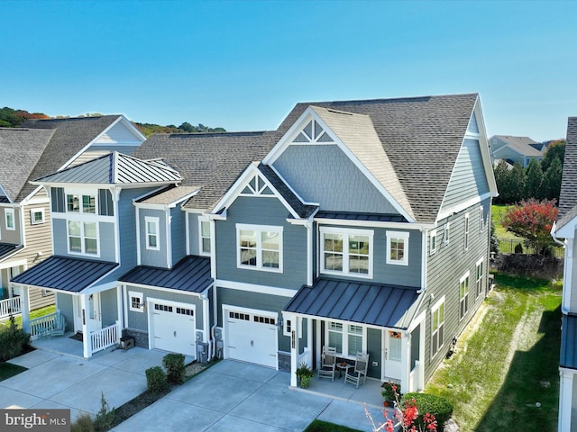 view of front of home with a garage and central air condition unit