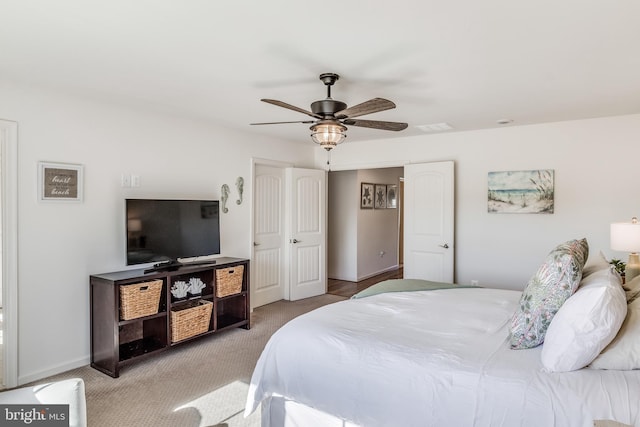 bedroom with light carpet and ceiling fan