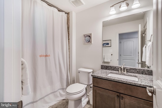 bathroom with walk in shower, vanity, and toilet