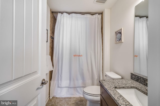 full bathroom featuring vanity, shower / bath combo, and toilet