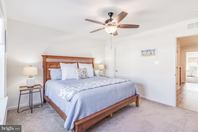 bedroom featuring ceiling fan and light carpet