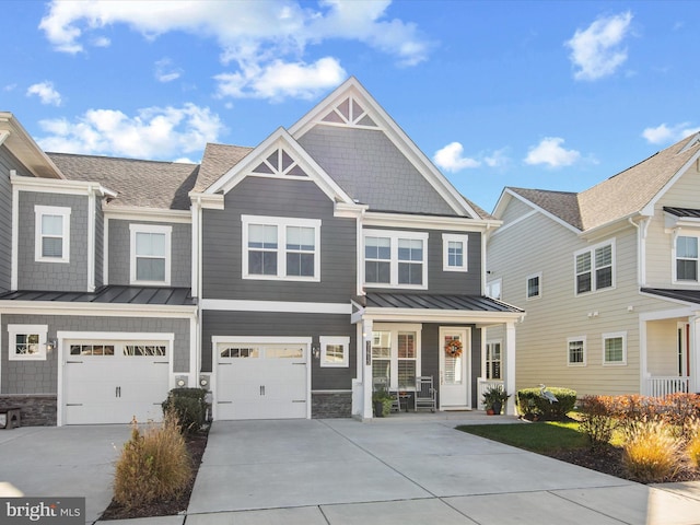 view of front of property with covered porch and a garage