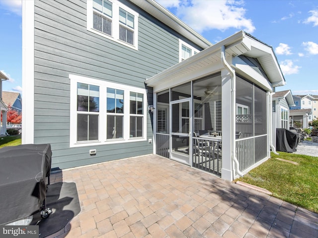 exterior space with a patio and a sunroom