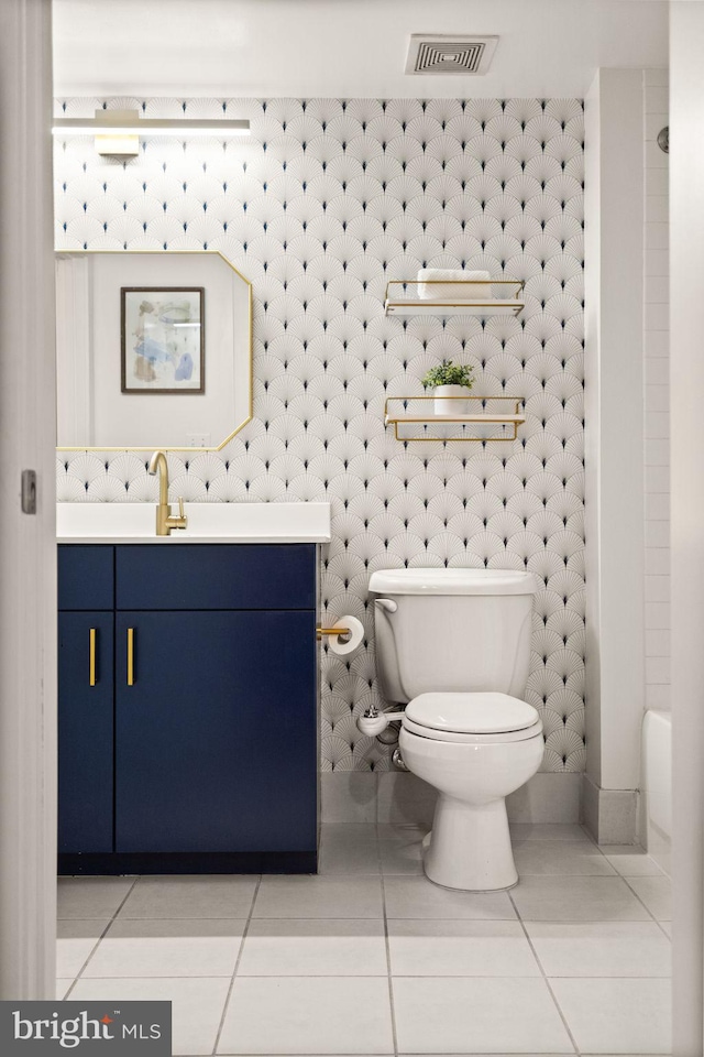 bathroom with tile patterned floors, vanity, and toilet